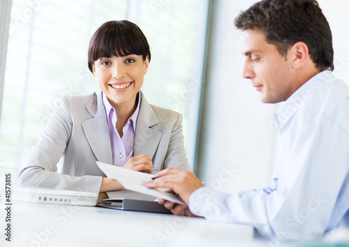 Photo: Woman smiling during job interview Woman smiling during job interview