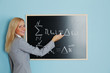 Foto: young woman teacher in front of a blackboard young woman teacher in front of a blackboard