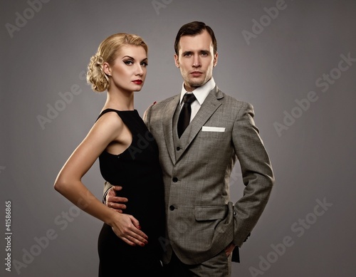 Photo: Retro couple on grey background. Retro couple on grey background.