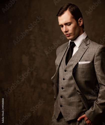 Photo: Man in grey suit. Man in grey suit.
