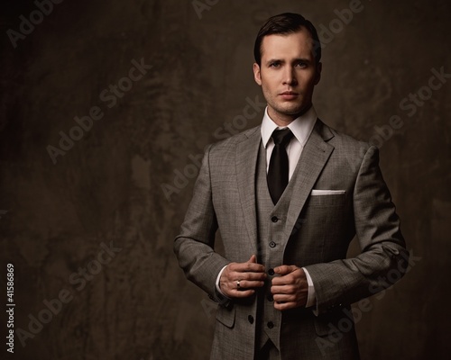 Photo: Man in grey suit. Man in grey suit.