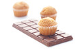 bar of dark chocolate and muffin isolated on white