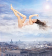 Conceptual photo of a beautiful brunette lying on clouds Conceptual photo of a beautiful brunette lying on clouds