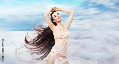Photo: Pretty brunette on heavenly bed Pretty brunette on heavenly bed