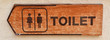 toilet plate sign on orange wall