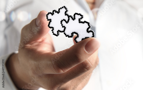 Photo: hand picking up pixel puzzles icon hand picking up pixel puzzles icon