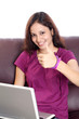 Young woman showing  thumb up while working on her computer