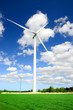 wind turbines at the meadow against blue sky