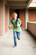 male middle school student running in school passage