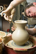 hands of a potter, creating an earthen jar on the circle