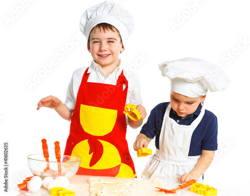 Photo: Two beautiful caucasian brothers making a cake Two beautiful caucasian brothers making a cake