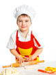 Beautiful caucasian boy making a cake
