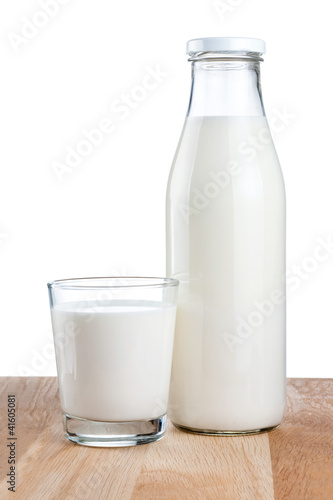 Photo: Bottle of fresh milk and glass is wooden table Isolated on white Bottle of fresh milk and glass is wooden table Isolated on white