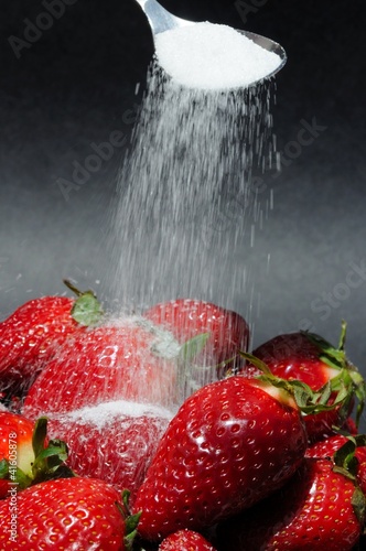 Photo: Sprinkling sugar onto strawberries © Arena Photo UK Sprinkling sugar onto strawberries © Arena Photo UK