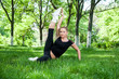 Beautiful teenage girl making exercises in the park in spring Beautiful teenage girl making exercises in the park in spring
