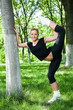 Beautiful teenage girl making exercises in the park in spring Beautiful teenage girl making exercises in the park in spring
