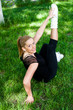 Beautiful teenage girl making exercises in the park in spring Beautiful teenage girl making exercises in the park in spring