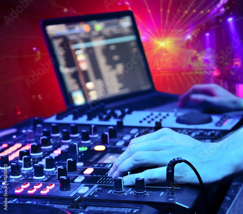 Photo: Dj mixes the track in the nightclub Dj mixes the track in the nightclub