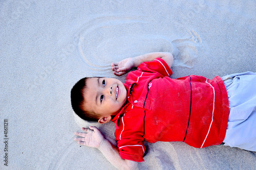 Photo: the boy relax on the beach the boy relax on the beach