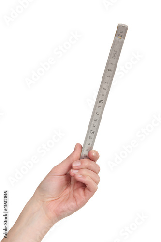 Foto: Female hand holding a ruler Female hand holding a ruler