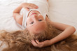 portrait of a child on the bed with her hair