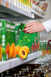 Photo: woman hand take box of juice in grocery store woman hand take box of juice in grocery store