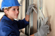 Tradeswoman installing electrical wiring