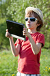 Foto: The fair-haired boy plays in the Tablet PC The fair-haired boy plays in the Tablet PC