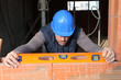 Man using spirit level to check wall