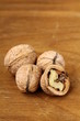 chopped and whole walnuts on a brown background chopped and whole walnuts on a brown background