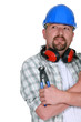 Tradesman holding a pair of pliers Tradesman holding a pair of pliers
