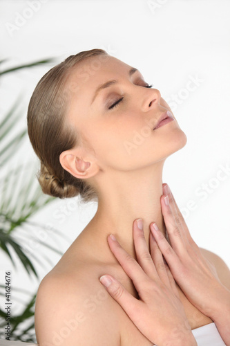Foto: Woman rubbing her own neck Woman rubbing her own neck