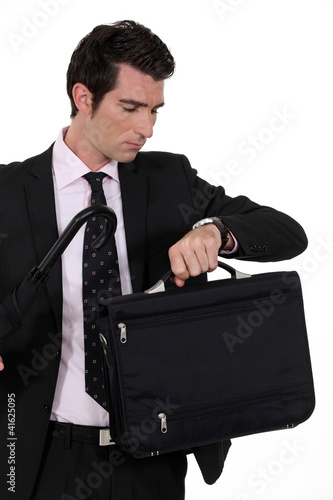 Photo: Businessman looking at his watch Businessman looking at his watch