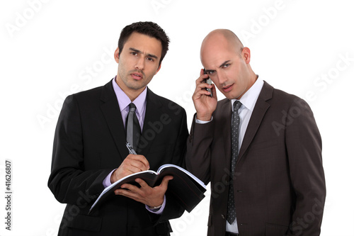 Photo: Serious businessmen with a cellphone Serious businessmen with a cellphone
