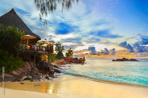 Photo: Cafe on tropical beach at sunset Cafe on tropical beach at sunset