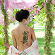 Asian style portrait of woman with snake tattoo on her back