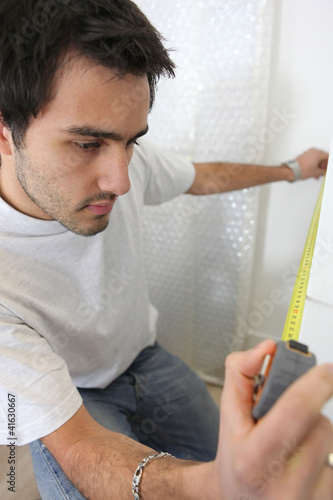 Photo: Man taking measurements Man taking measurements