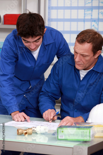 Photo: blue collars in office: apprentice and instructor blue collars in office: apprentice and instructor