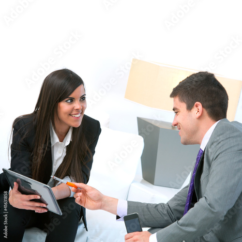 Photo: Business couple at meeting with tablet. Business couple at meeting with tablet.