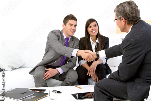 Photo: Young couple at meeting with financial planner. Young couple at meeting with financial planner.
