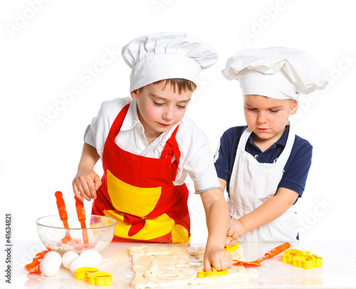 Photo: Two beautiful caucasian brothers making a cake Two beautiful caucasian brothers making a cake