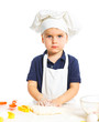 Beautiful caucasian boy making a cake