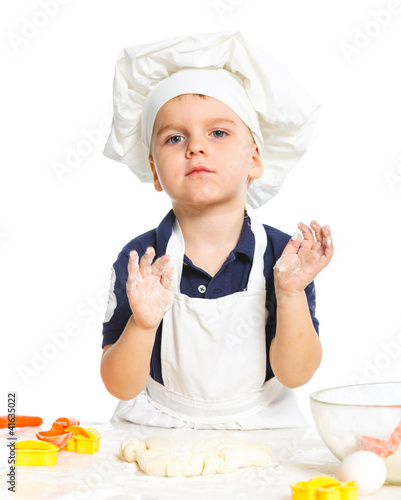 Photo: Beautiful caucasian boy making a cake Beautiful caucasian boy making a cake