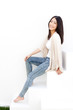 attractive young woman sitting on white stair