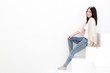attractive young woman sitting on white stair