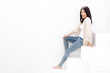 attractive young woman sitting on white stair