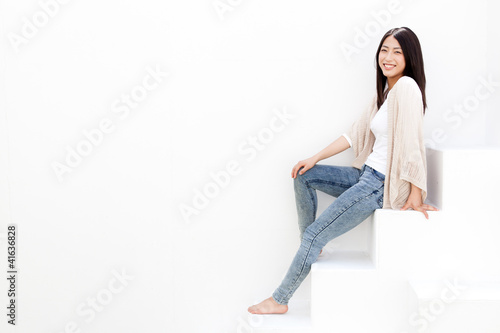 Photo: attractive young woman sitting on white stair attractive young woman sitting on white stair