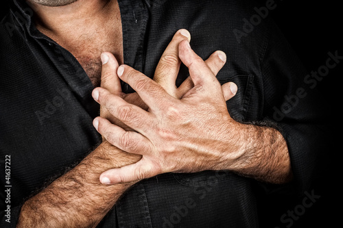 Photo: Chest pain concept - Two hands touching chest Chest pain concept - Two hands touching chest