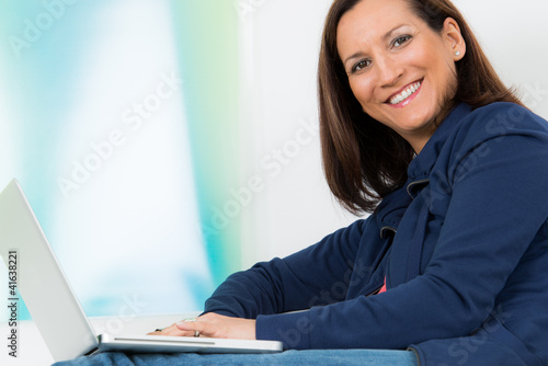 Photo: glückliche brünette frau mit ihrem laptop glückliche brünette frau mit ihrem laptop