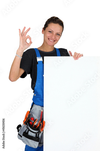 Photo: construction worker with tool belt and a board for your message construction worker with tool belt and a board for your message